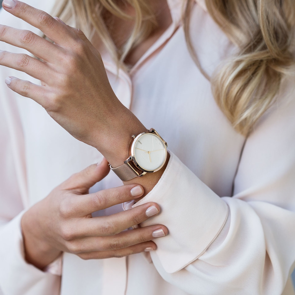 Close-up of woman wearing watch, light clothing, elegant style, fashion