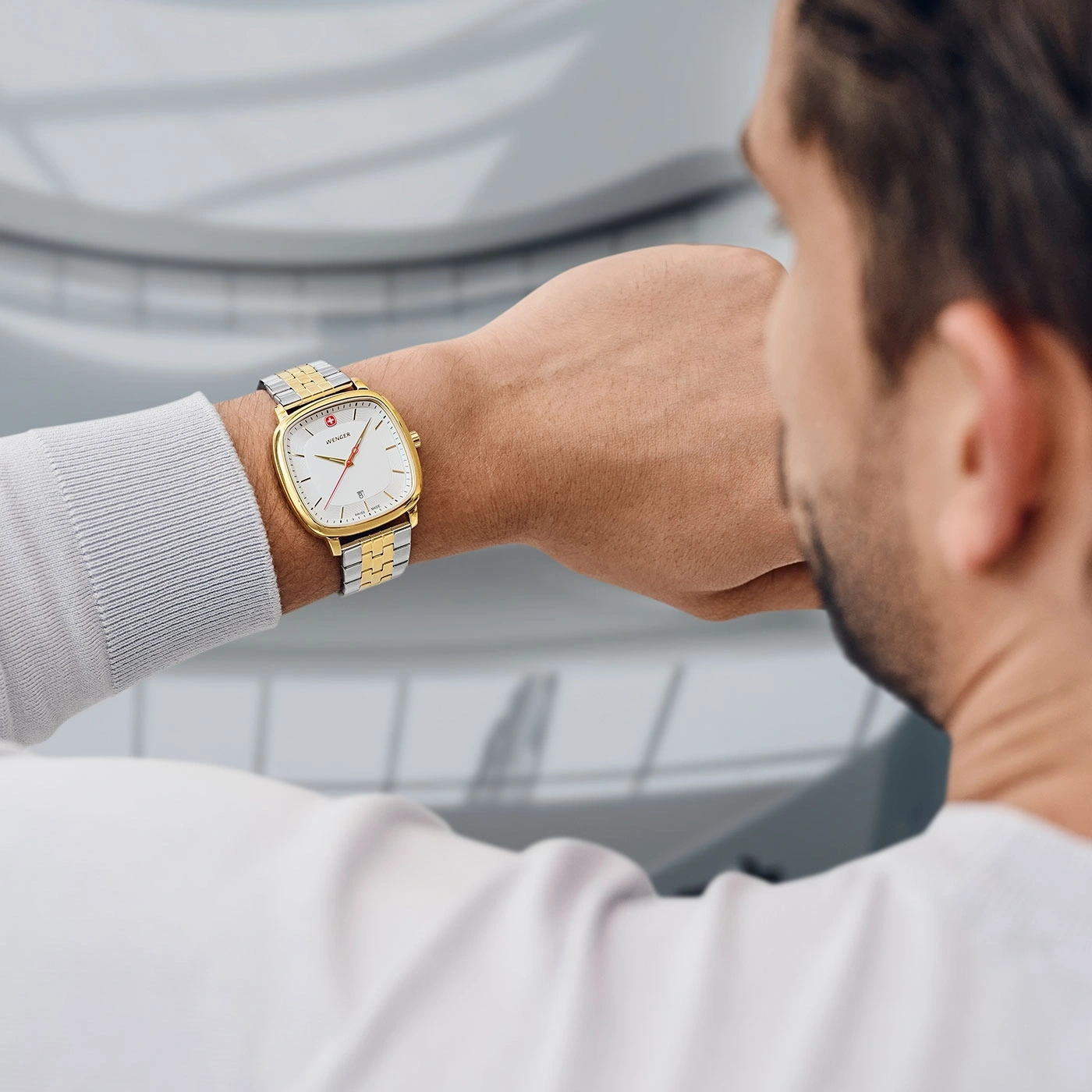 Man wearing a gold watch on his wrist, close-up shot of the watch