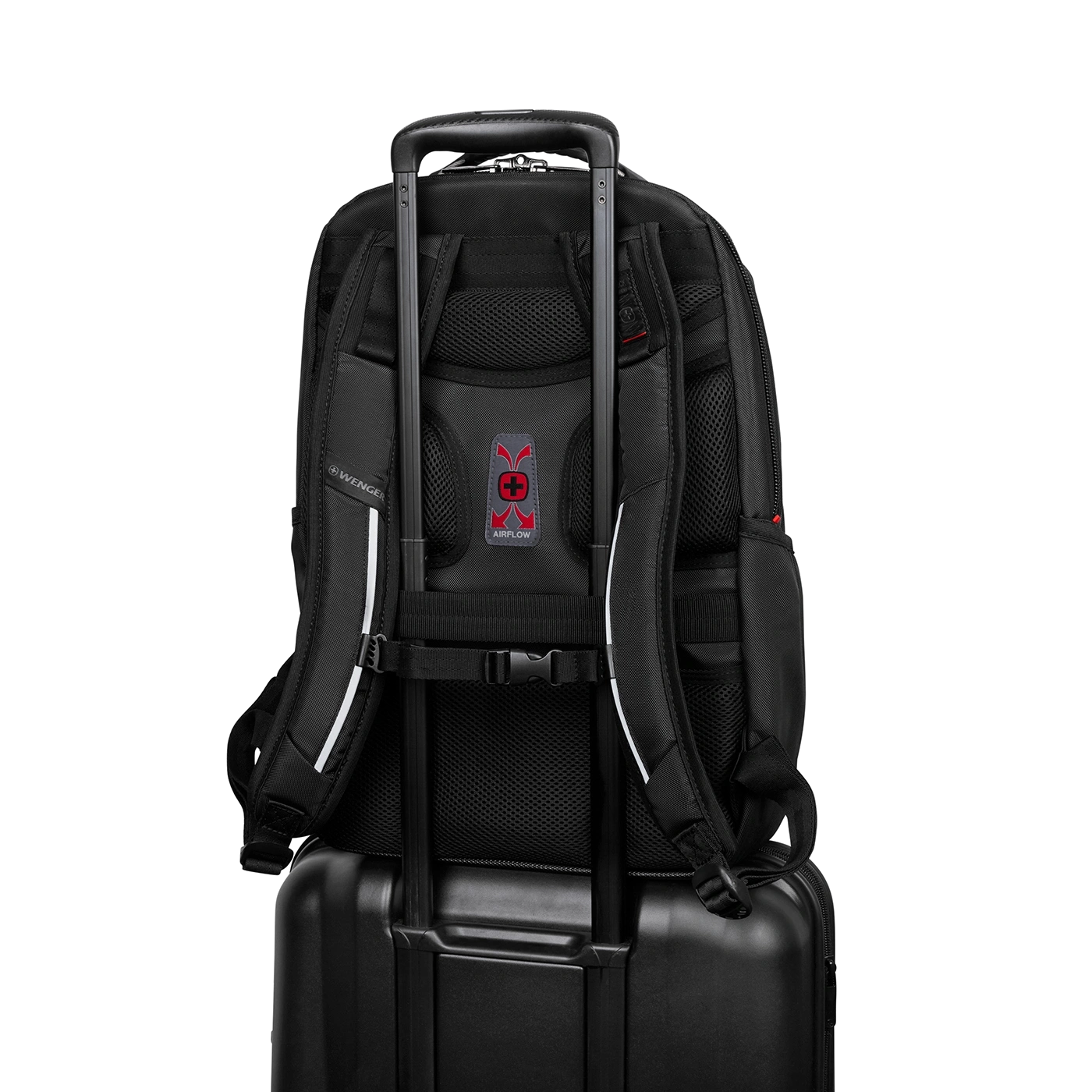 Black backpack on a black suitcase. Wenger brand, Airflow system, carrying handle.