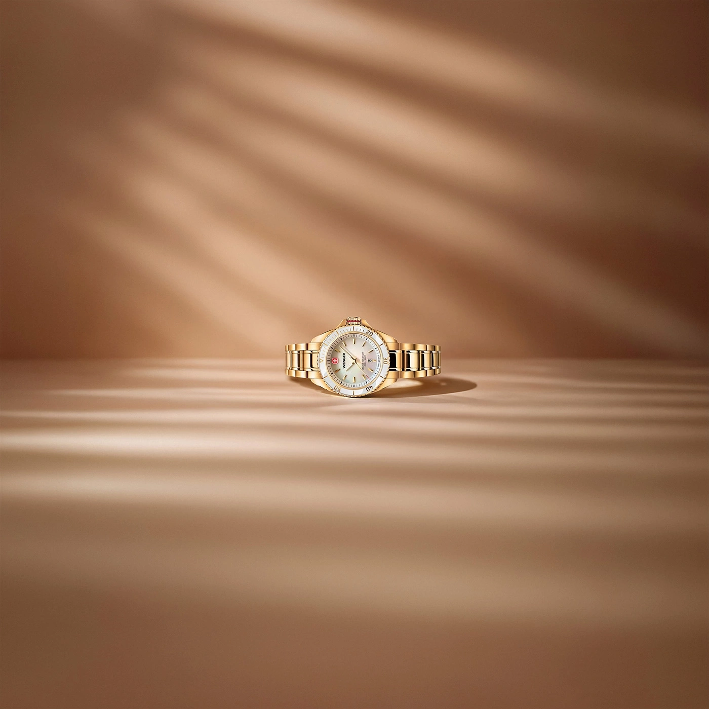 Gold ladies watch with mother-of-pearl dial and silver accents