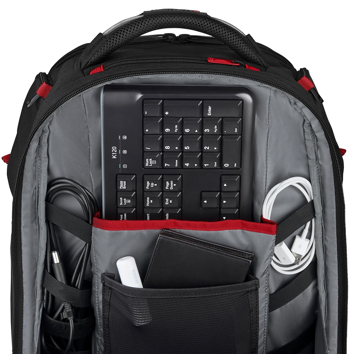 Black backpack with keyboard, cables, and accessories. Well organized and packed for travel.