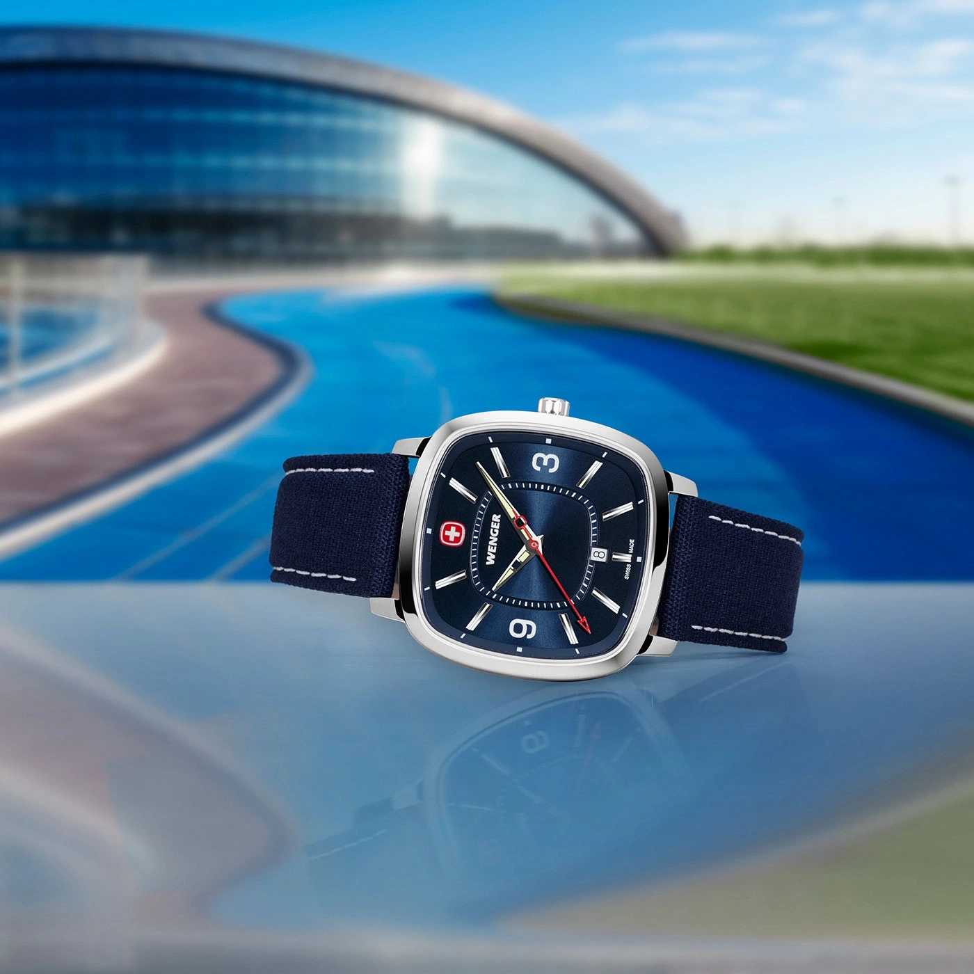 Wenger watch with blue face and strap against a blue background