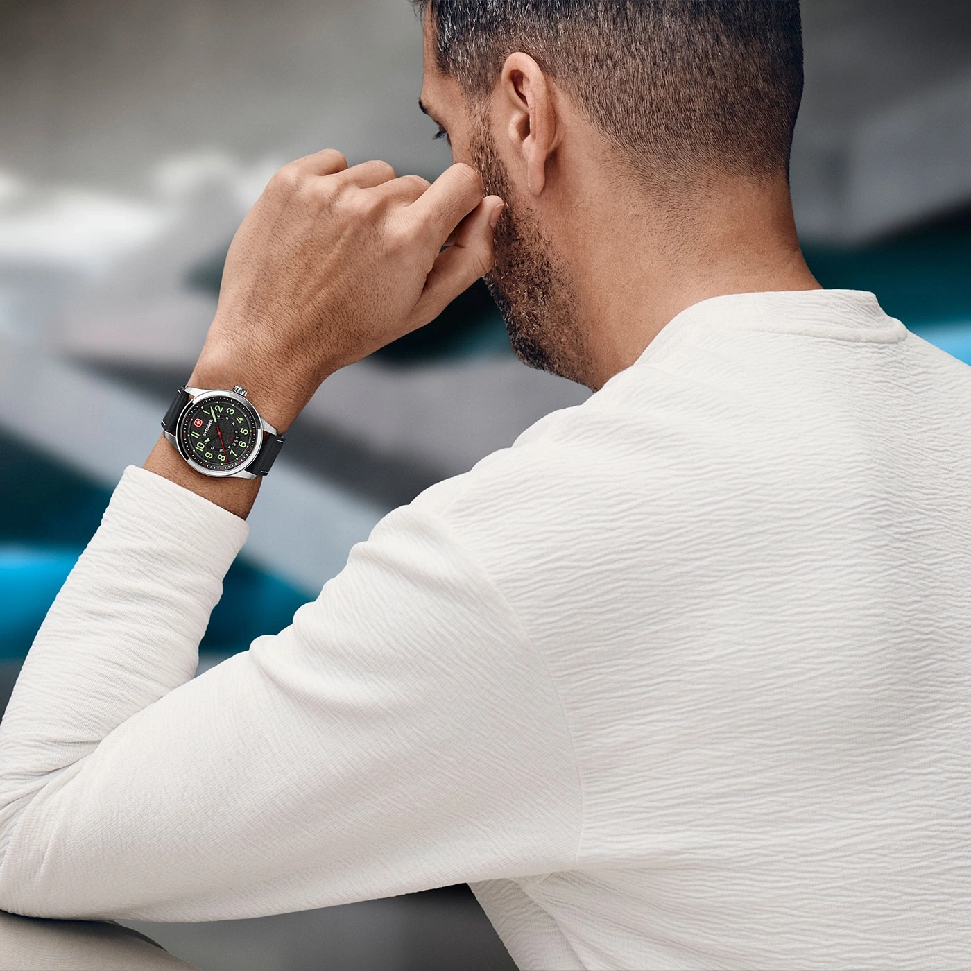 Man wearing watch, looking thoughtful, white shirt, hand on face, close up