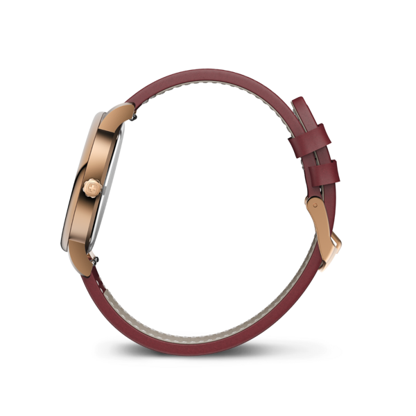 A rose gold watch with a red leather strap shown from the side.