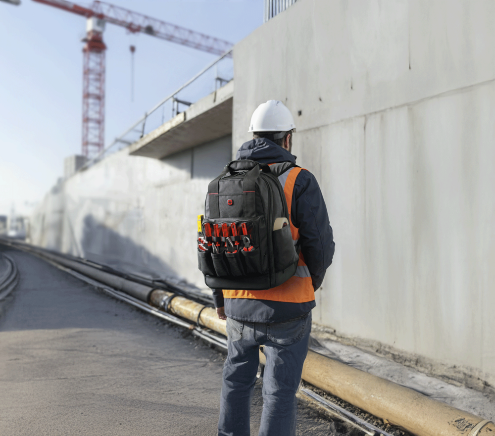 Construction worker with tool backpack at construction site