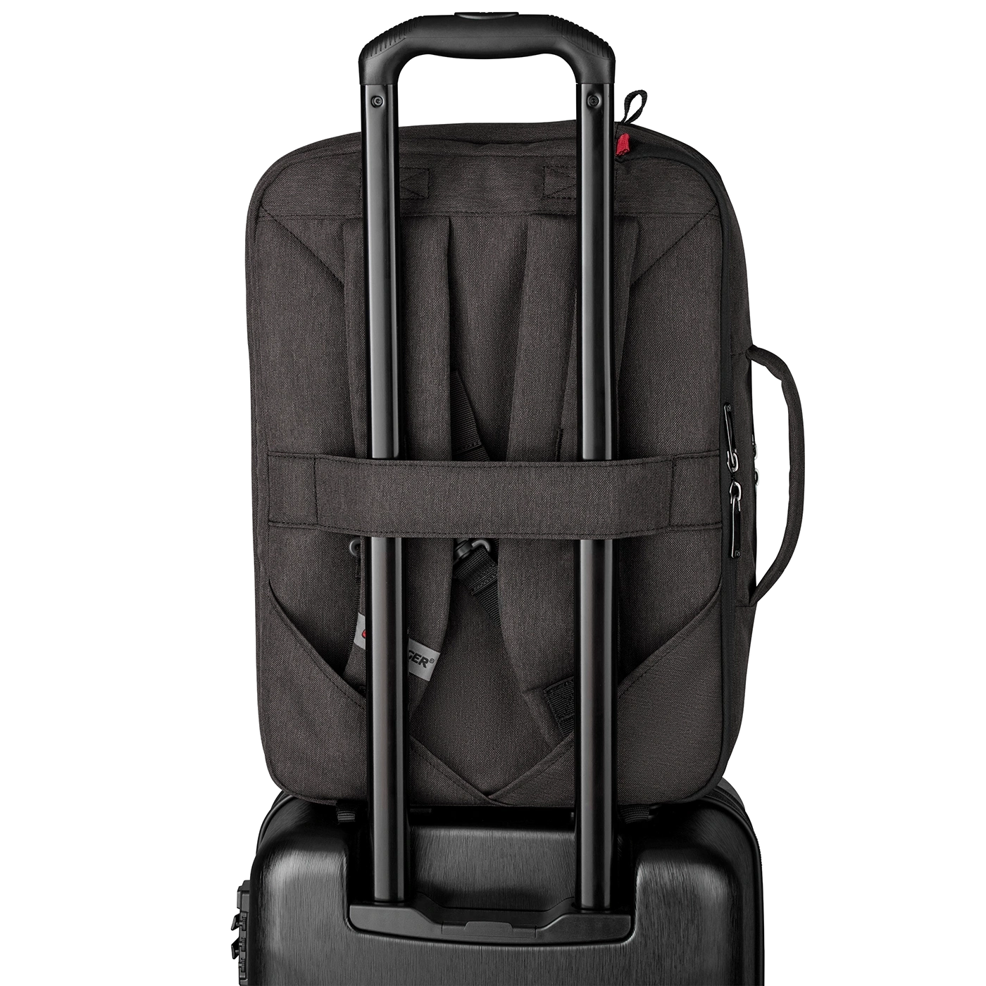 Black backpack on a suitcase with a retractable handle, ready for travel.