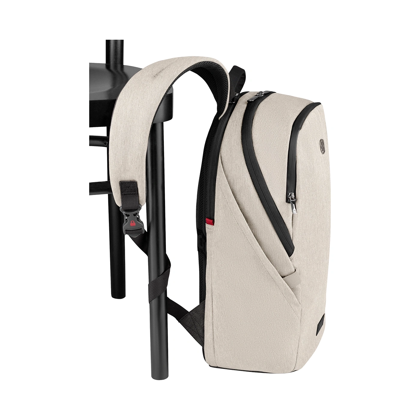 Beige backpack leaning on black chair, featuring black zippers and details, isolated.