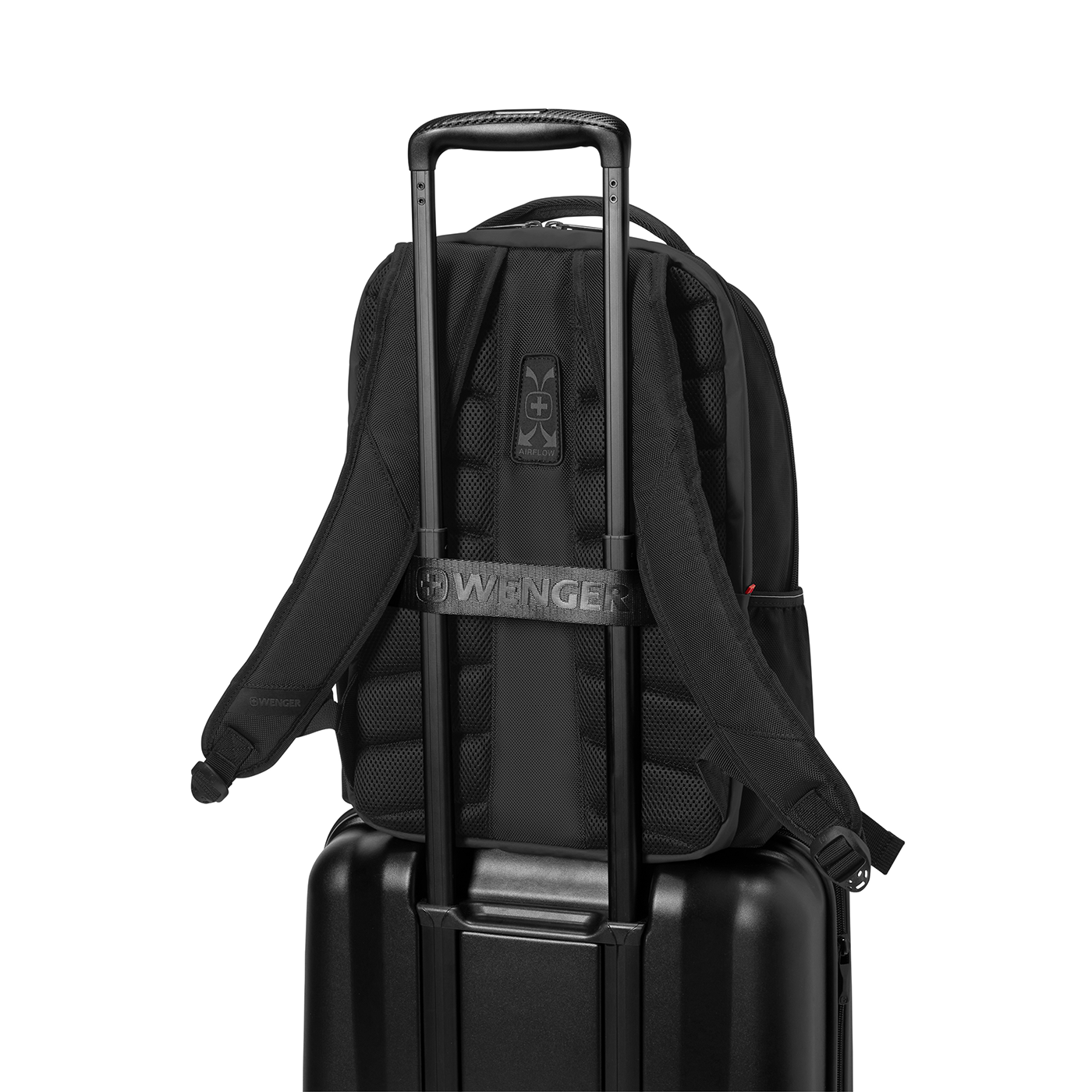 Black backpack on black suitcase with handle, Wenger logo, against black background.