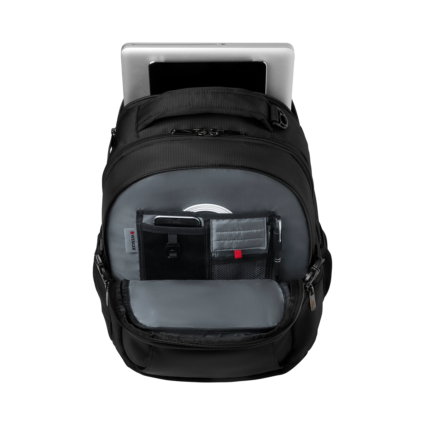 Black backpack with laptop and accessories, open, on a black background.