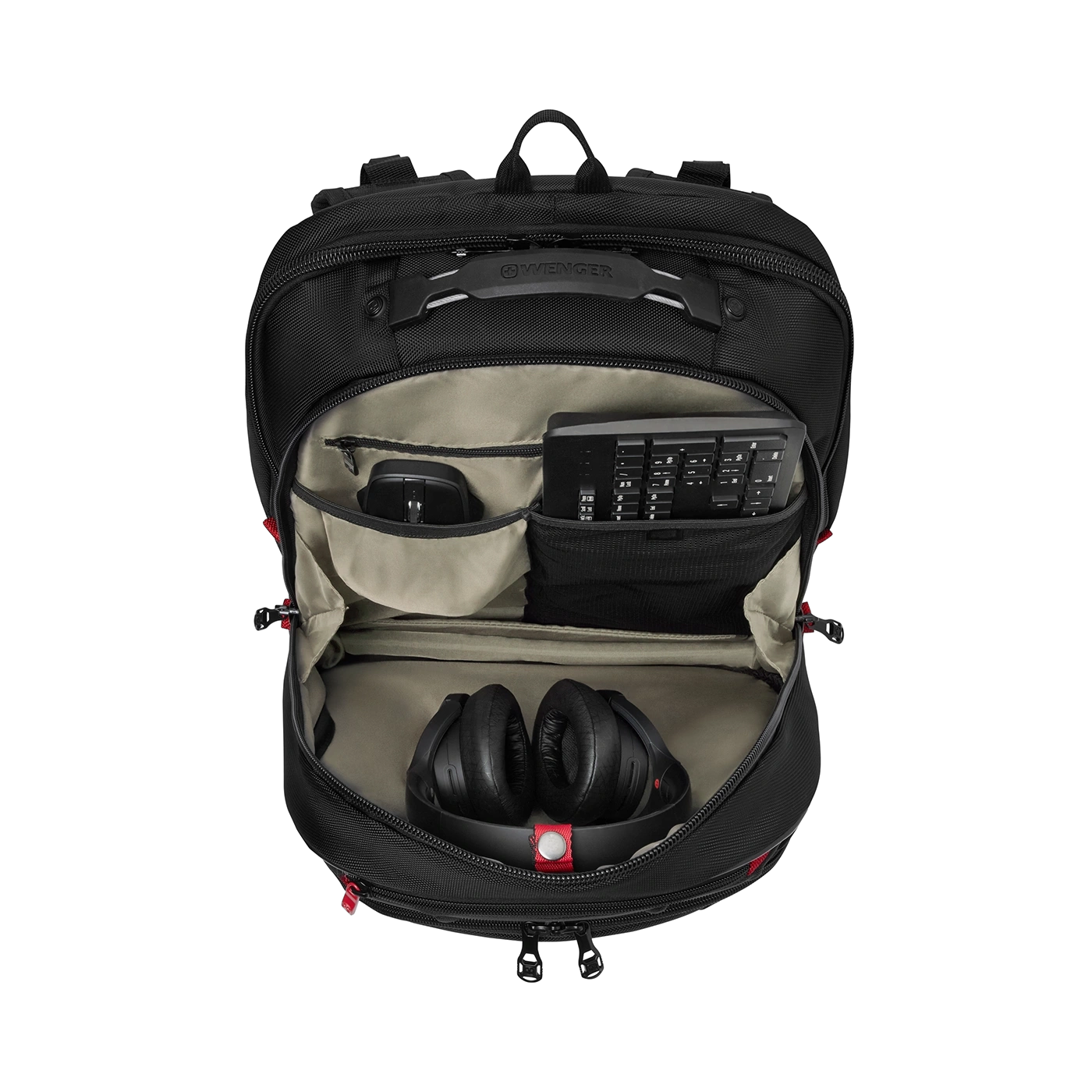 Black backpack with headphones, mouse and keyboard open on a black background.