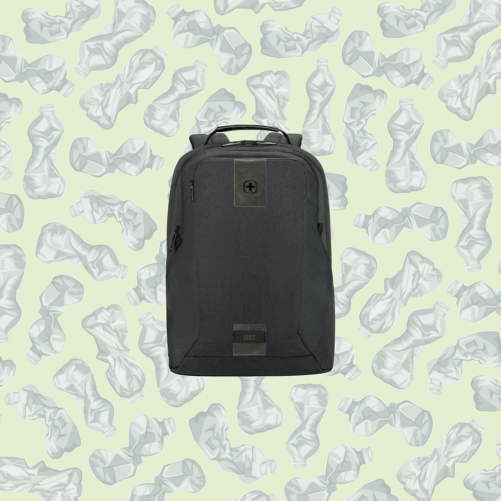 Black backpack in front of a background of crumpled plastic bottles.