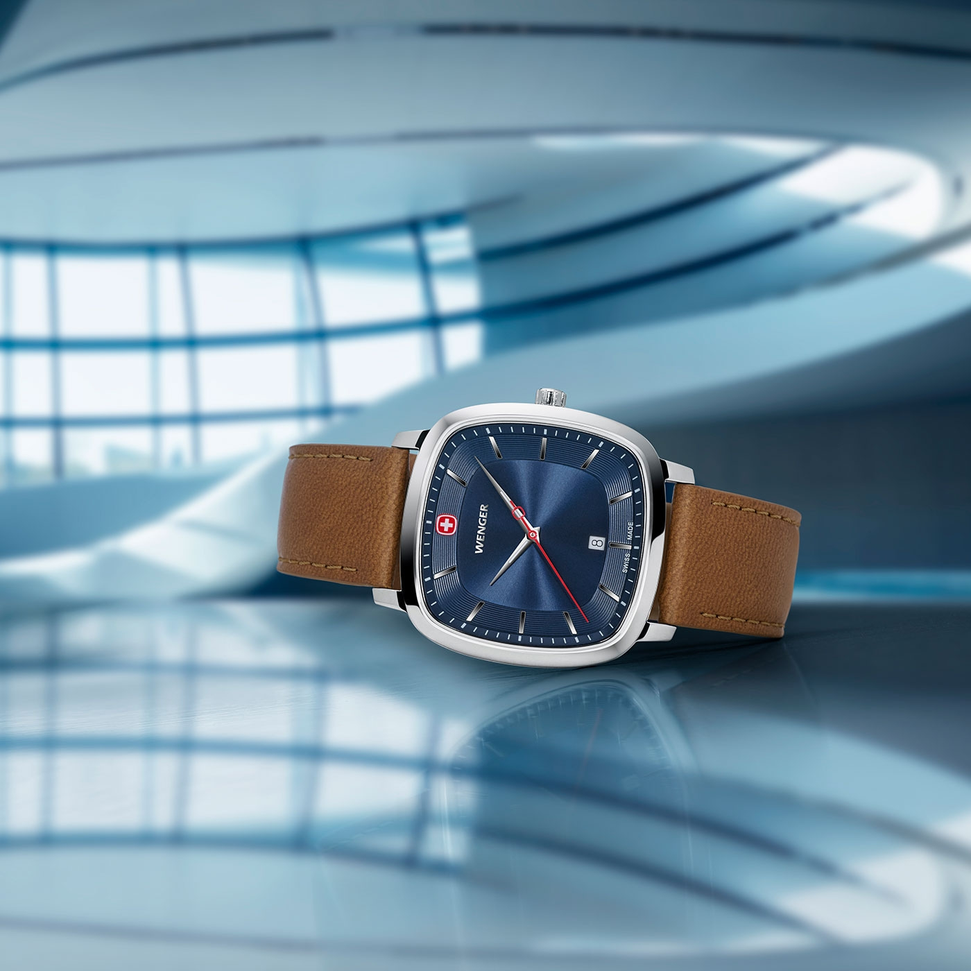 Wenger watch with blue face and brown leather strap, close-up shot