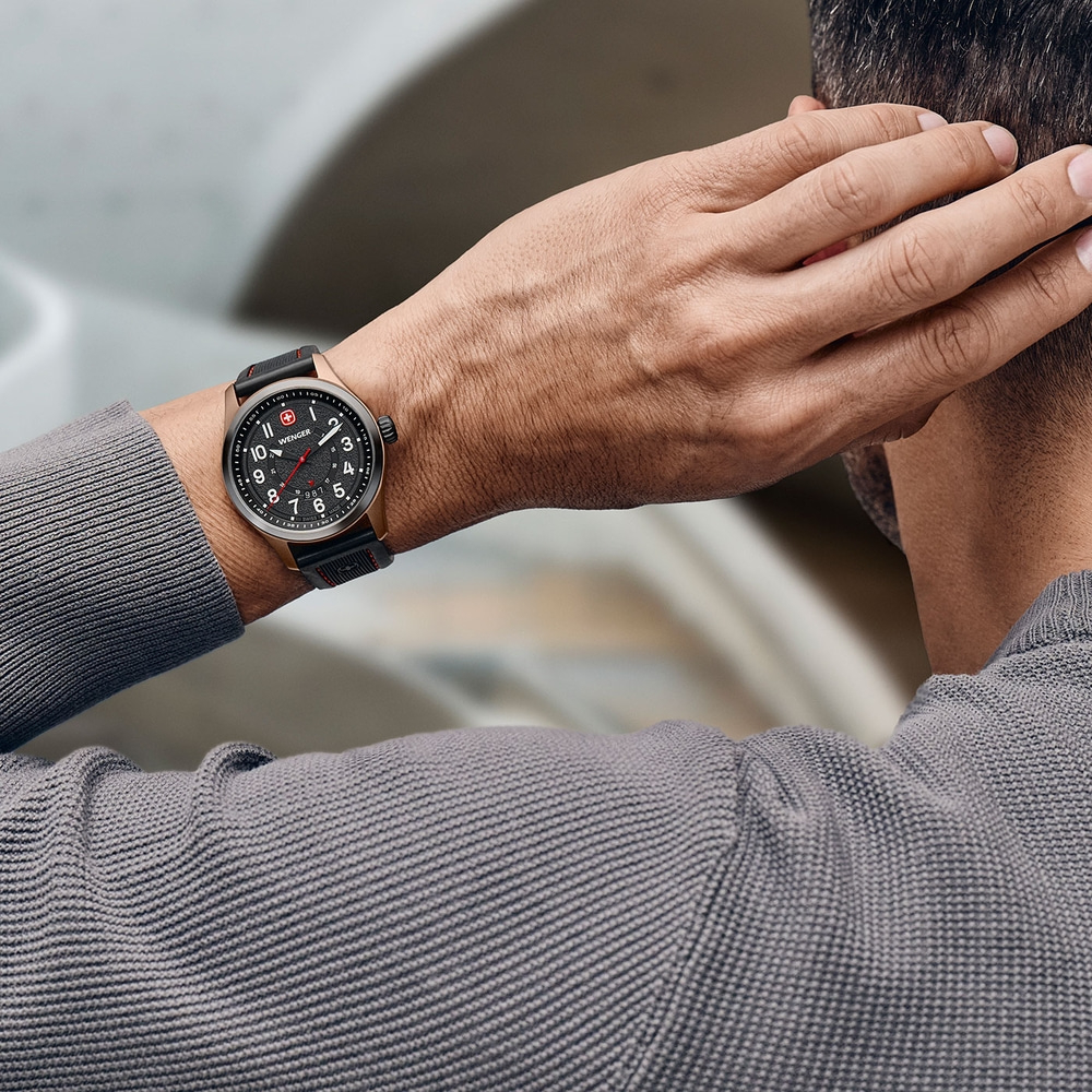 Man with watch scratching head, gray shirt, close-up shot, wrist watch