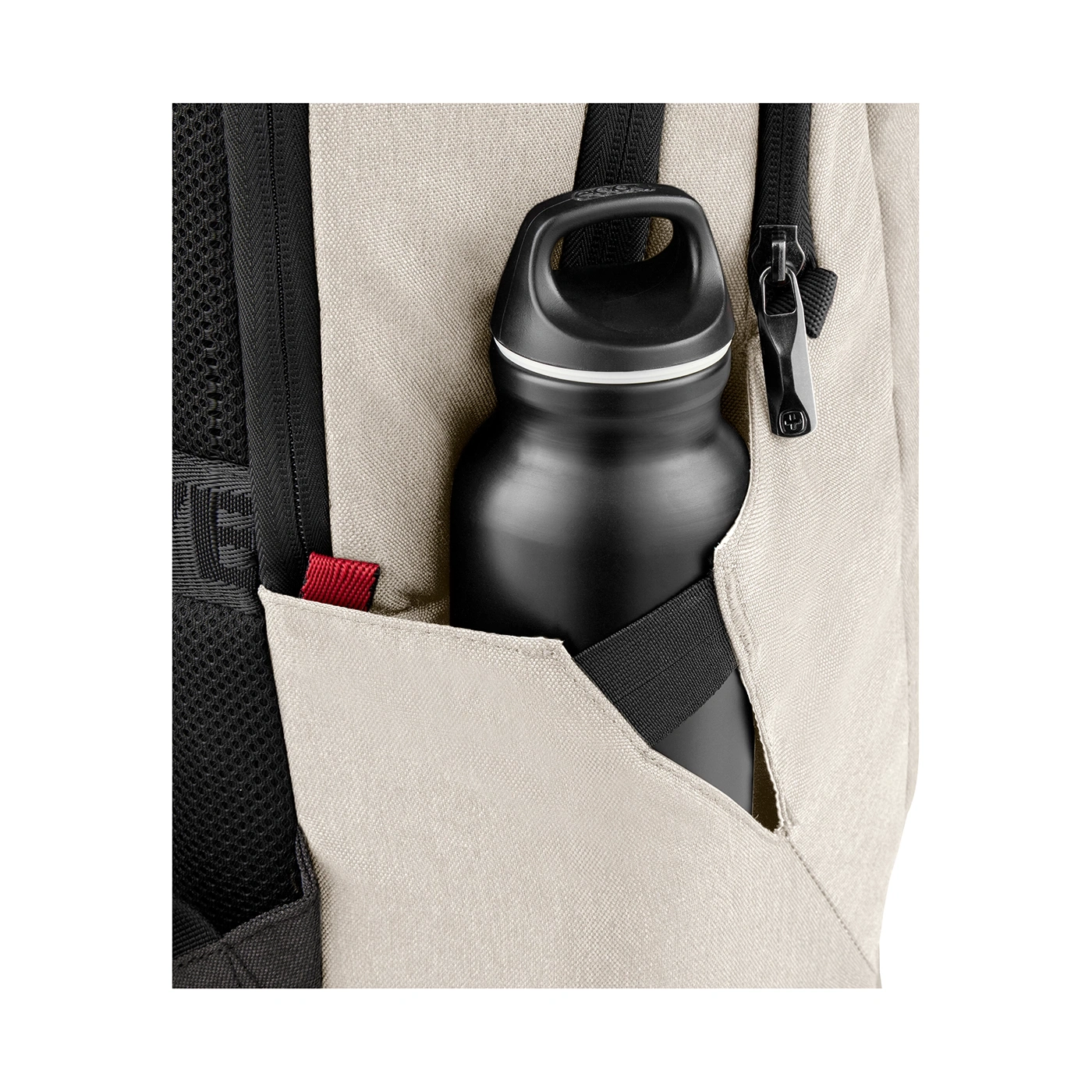 Black water bottle in a light backpack pocket with zipper and red detail.