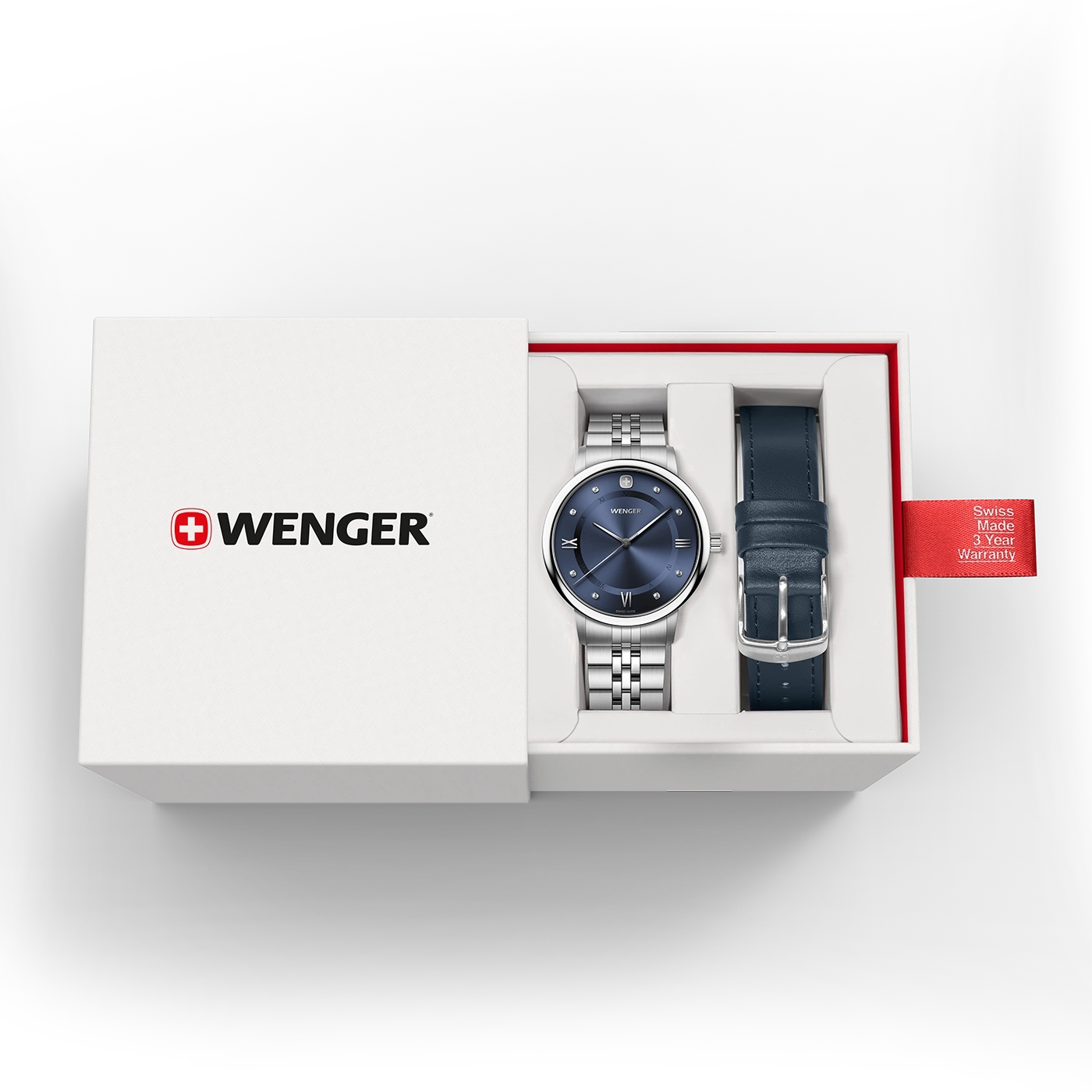 Wenger-Armbanduhr mit blauem Zifferblatt und zusätzlichem dunkelblauem Lederarmband in einer weißen Geschenkbox mit rotem Swiss-Made-Garantieanhänger.