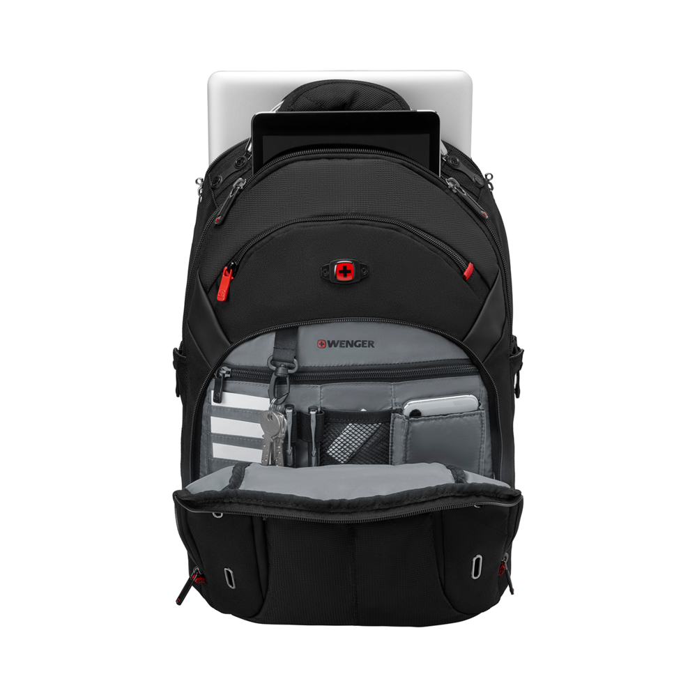 Black backpack with laptop, tablet, and accessories, open on a black background.