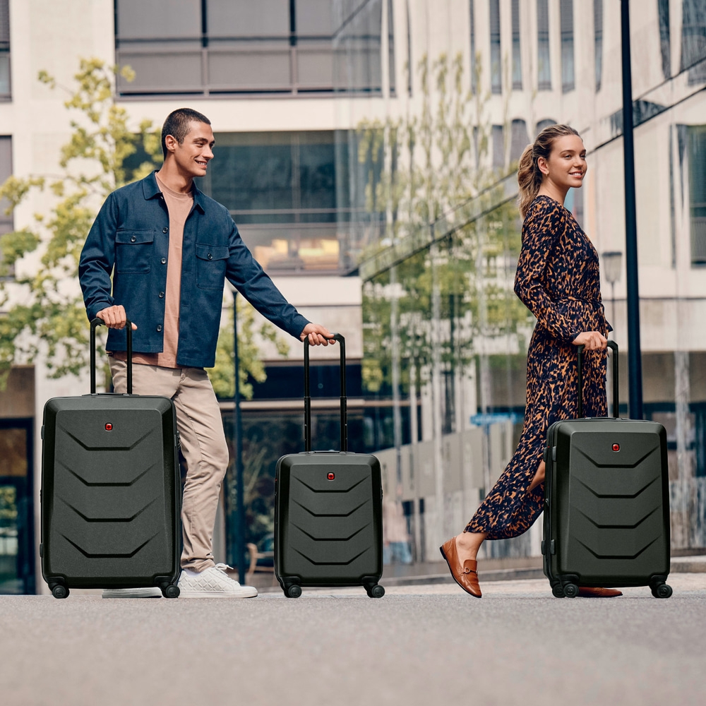 Man and woman with suitcases walking on street. Travel, vacation, luggage.