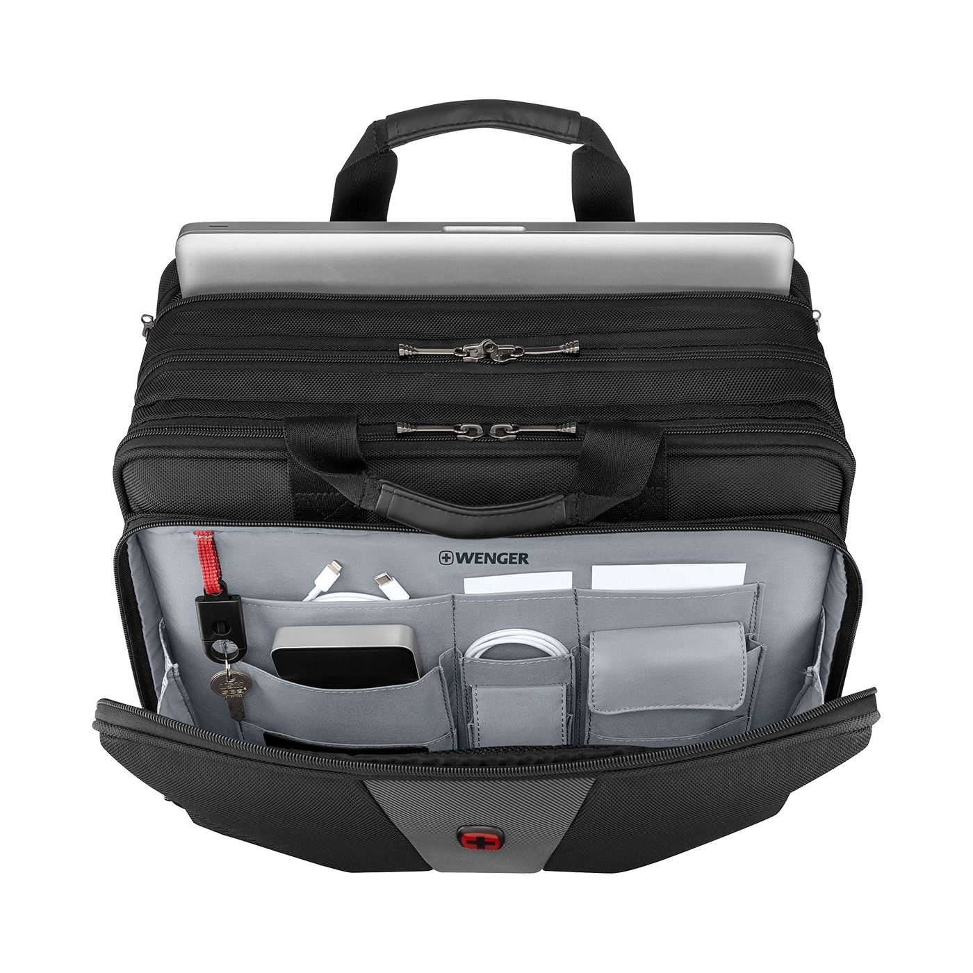 Black briefcase with laptop and accessories, open, seen from above.