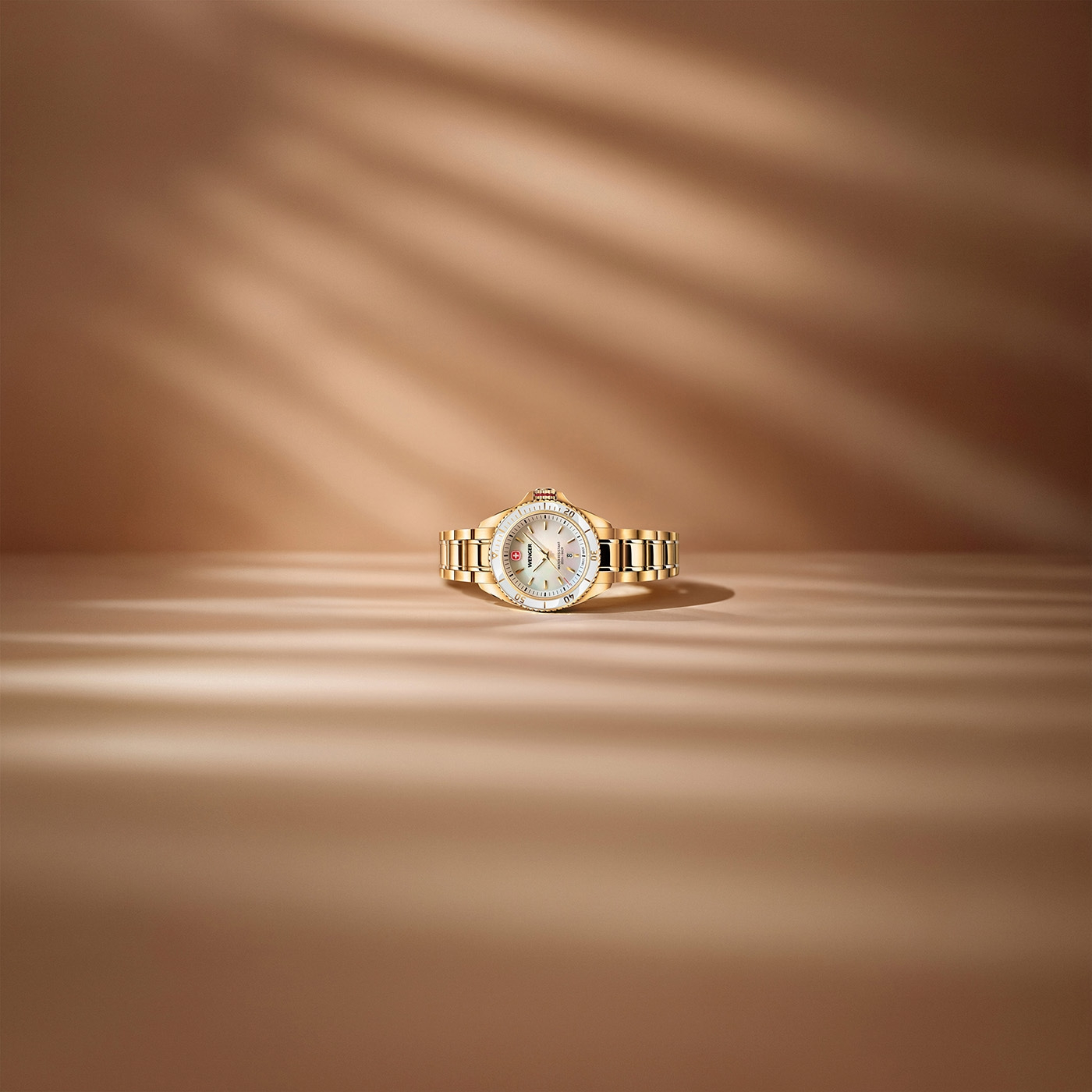 Gold ladies watch with mother-of-pearl dial and silver accents