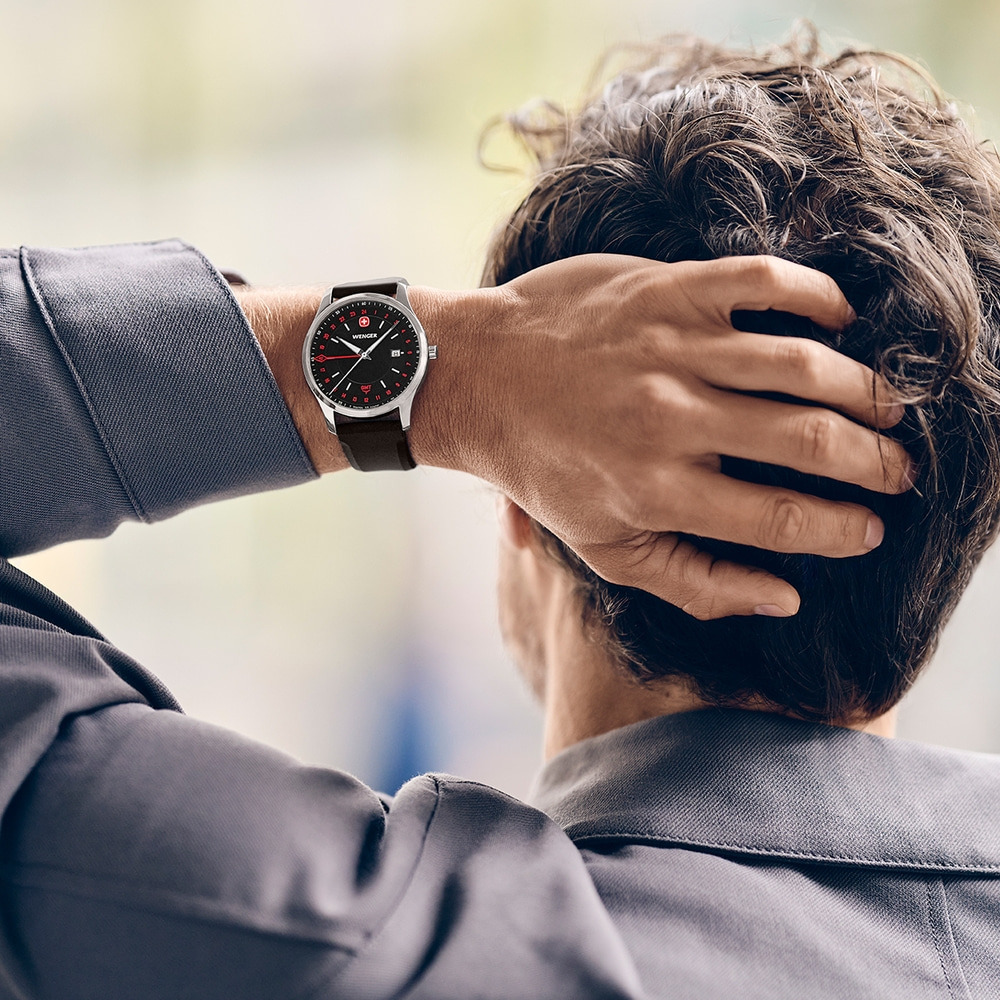 Man scratching head with watch on wrist