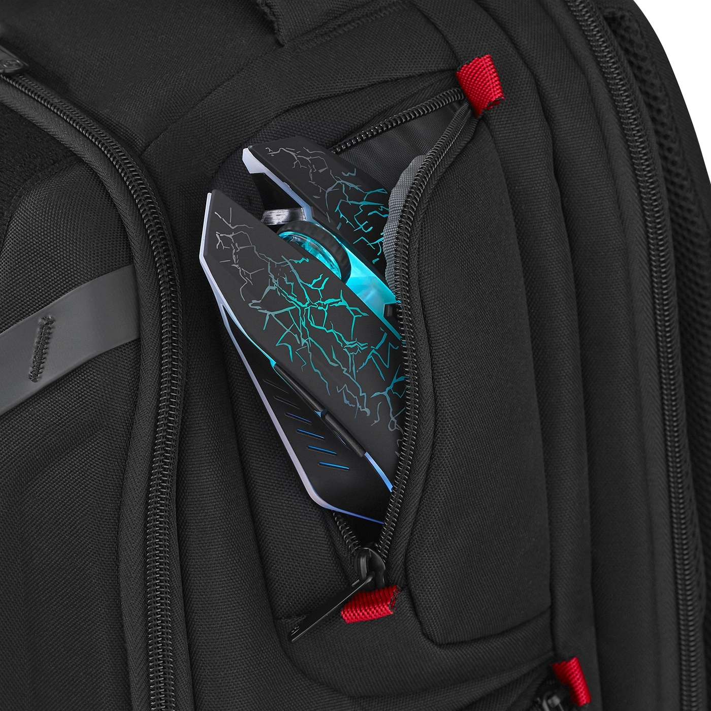Black backpack with gaming mouse in pocket, close-up shot, detail.