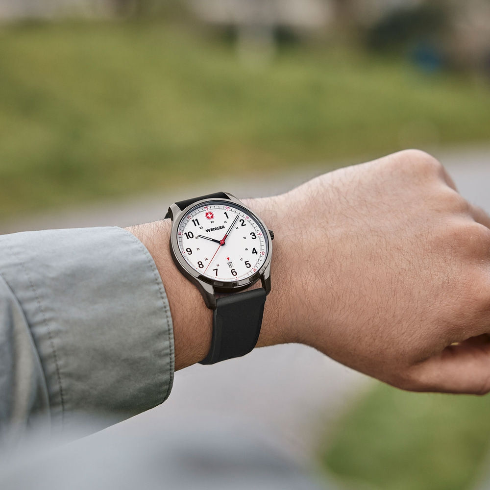 Wristwatch on wrist, white dial, black strap, Wenger brand, close-up shot